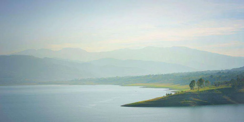 A large body of water surrounded by mountains