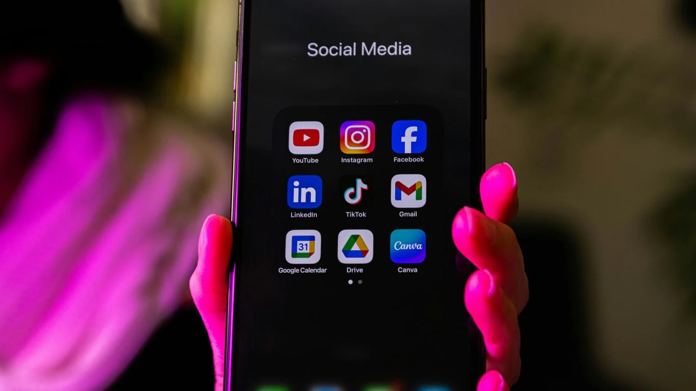 A smartphone displays social media app icons.